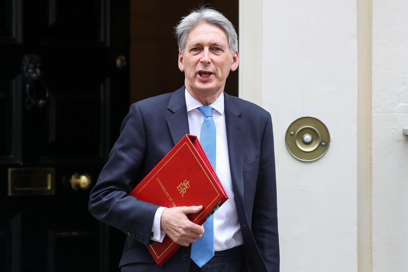 Philip Hammond, U.K. chancellor of the exchequer, leaves number 11 Downing Street to present the Spring Statement in Parliament in London, U.K., on Tuesday, March 13, 2018. This year Hammond has decided to do things differently, moving the main Budget announcement to the Autumn and reducing the Spring Statement one to a handful of forecasts on the shape of the economy that will last less than half an hour. Photographer: Simon Dawson/Bloomberg