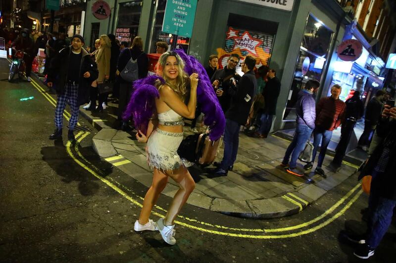 A woman dances in the West End of London. AP Photo