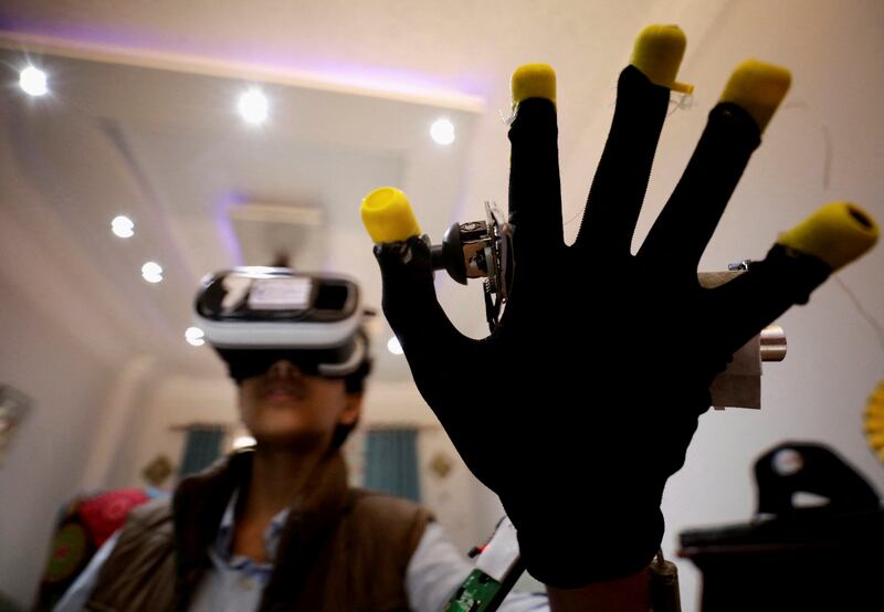 Omar Wael, 13, an Egyptian developer, uses a virtual reality device as he works at his home in Alexandria, Egypt. All photos: Reuters