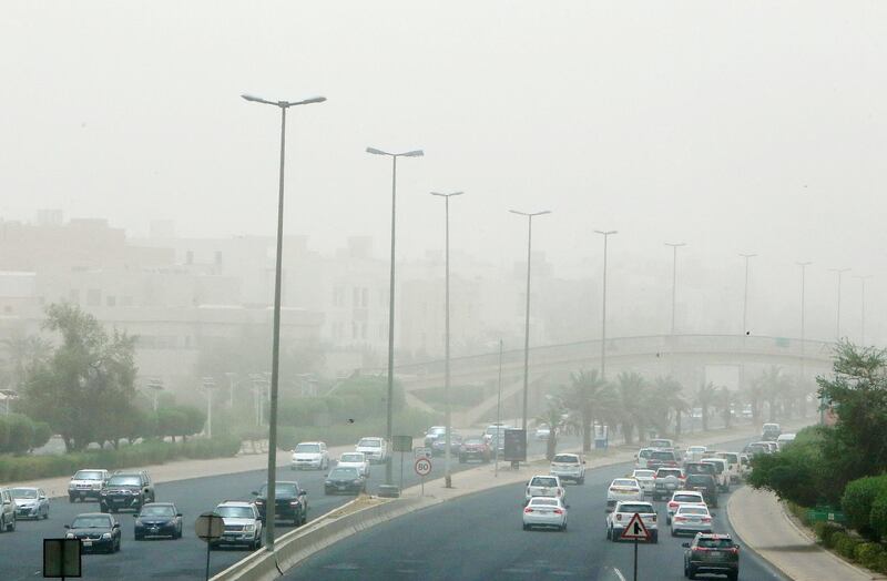 Vehicles drive along a motorway during a dust storm in Kuwait City. AFP