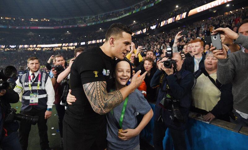 New Zealand's Sonny Bill Williams gives his 2015 Rugby World Cup winner's medal to a fan. EPA