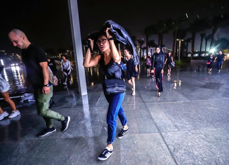Abu Dhabi, U.A.E., November 12, 2018.  
Cancelled concert of Dua Lipa at the Louvre due to a sudden downpour and gusty winds.  Concert goers take refuge at the Louvre Museum area.
Victor Besa / The National
Section:  NA
Reporter: