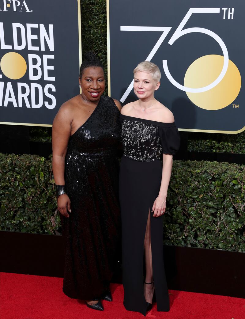 Michelle Williams, in black Louis Vuitton, and Tarana Burke at the 75th annual Golden Globe Awards in Beverly Hills, California on January 7, 2018. EPA