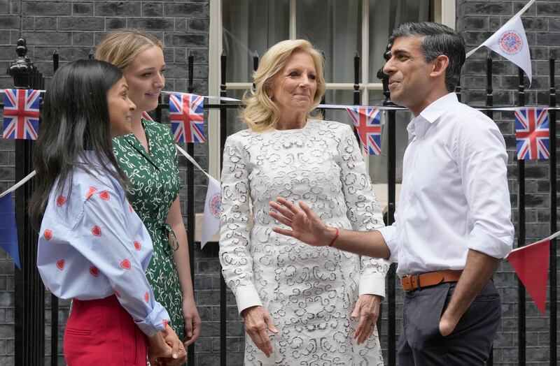 Wearing a love-heart adorned Boden blouse blue with tailored red power trousers outside 10 Downing Street, London. Getty Images 