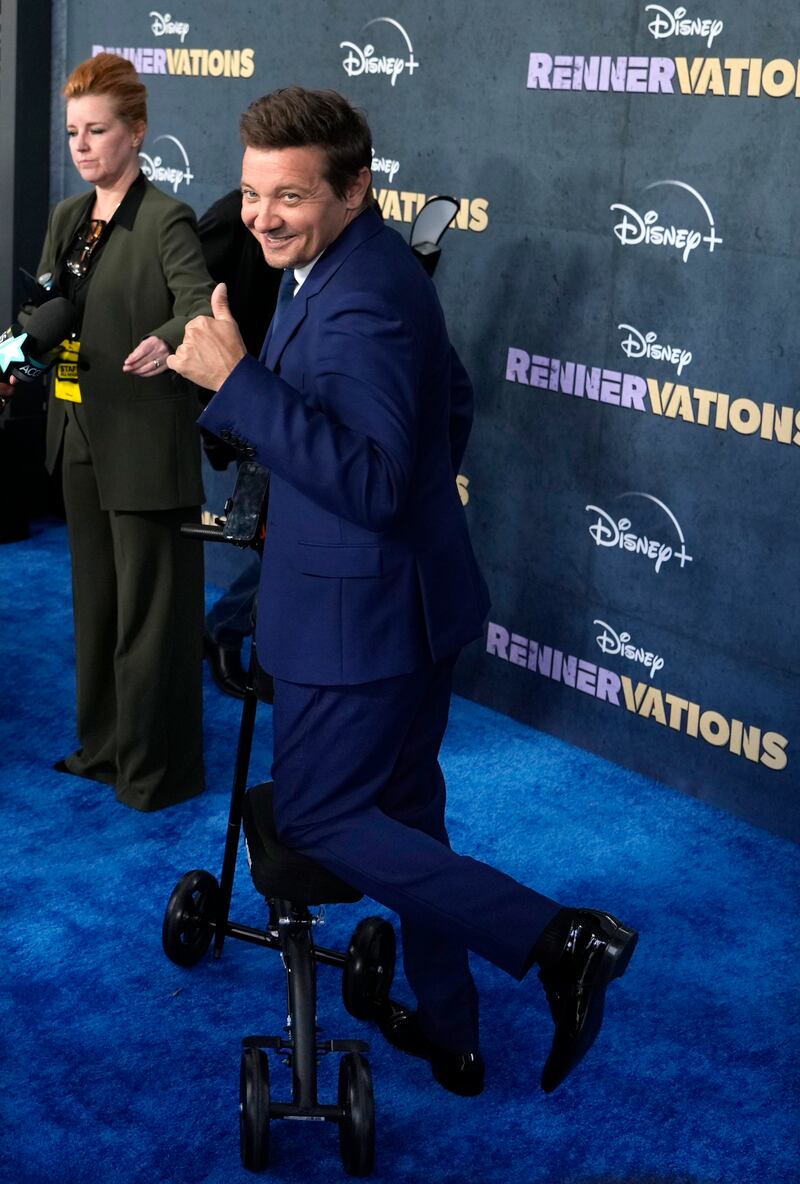 On the red carpet Renner posed for photos and did interviews, at times making use of a cane and a knee scooter. AP Photo