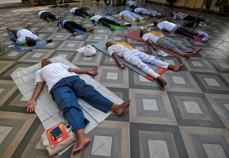 People perform yoga outside a residential house in Ahmedabad. Reuters