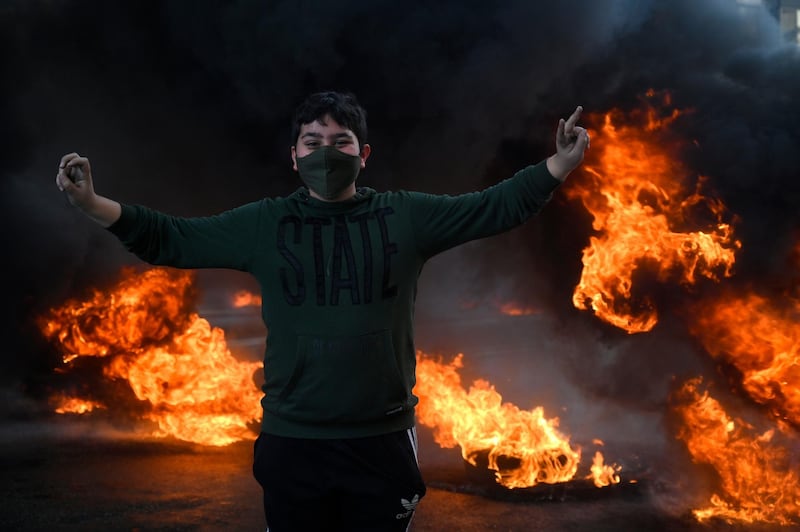 A demonstrator against power cuts stands in front burning tyres in Beirut, Lebanon. EPA
