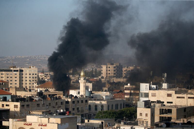 Smoke rises among buildings during the Israeli military operation in Jenin camp, in the West Bank. EPA