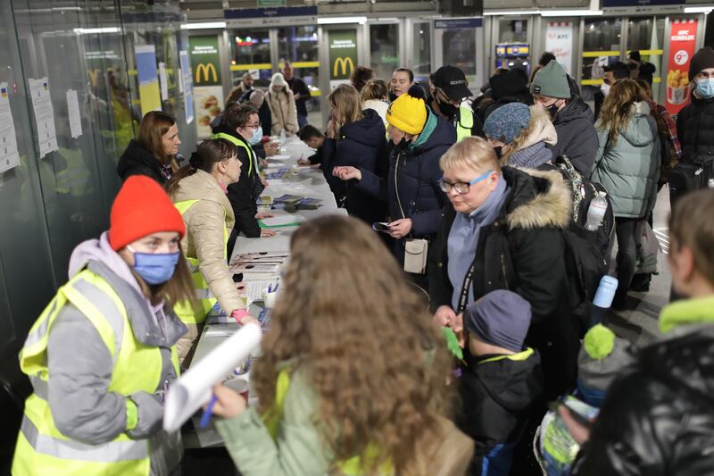 Ukrainian refugees who arrived by evening train from Kiev to Warsaw are helped at the Warszawa Wschodnia railway station in the Polish capital. EPA