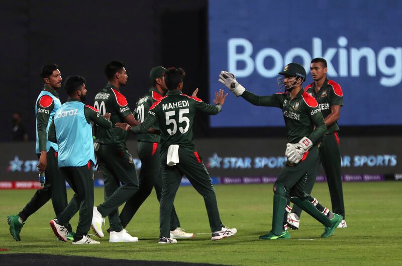 Bangladesh's Mustafizur Rahman, second left, celebrates with teammates after taking a catch of Oman's captain Zeeshan Maqsood. AP