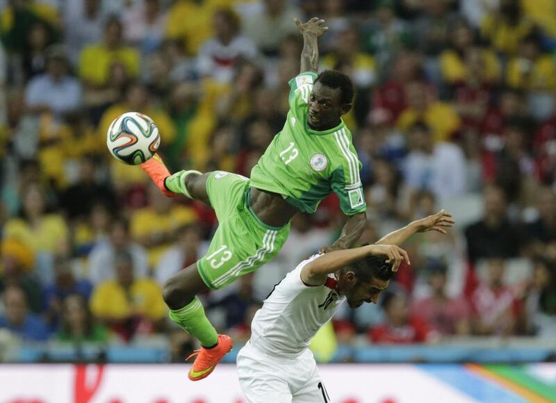 Nigeria's Juwon Oshaniwa jumps for the ball with Iran's Reza Ghoochannejhad during their 2014 World Cup Group F match on Monday in Curitiba, Brazil. Henry Romero / Reuters