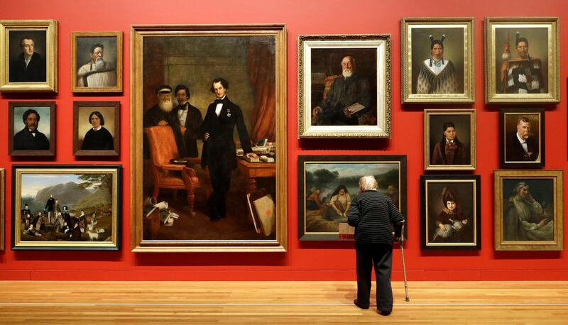 A visitor to Te Papa Museum looks at an exhibition of portraits in Wellington, New Zealand. Mark Baker / AP Photo