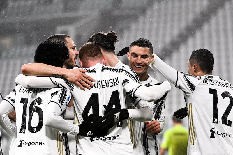 Juventus' Cristiano Ronaldo celebrates with teammates after Roma's Roger Ibanez scored an own goal. AP