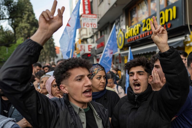 Supporters of the pro-Kurdish Peoples' Equality and Democracy Party protest after its candidate in Sunday's municipal elections in the city of Van was ruled ineligible. AFP