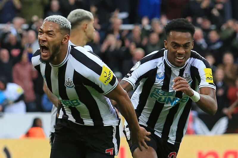 Brazilian striker Joelinton celebrates with Joe Willock (R) after adding third goal. AFP