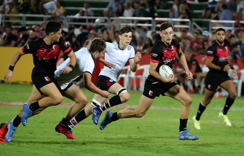 Dubai English Speaking College (black) on their way to victory over Dubai College in the Gulf Under 19 boys cup final at The Sevens on the second day of the Emirates Dubai Rugby Sevens on December 3, 2021. DESC won the match 36-14 on. All photos Pawan Singh / The National