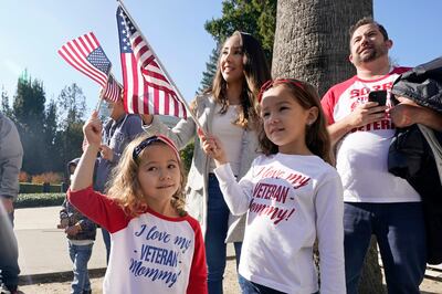 A family attend a Veteran's Day parade in Sacramento, California. AP