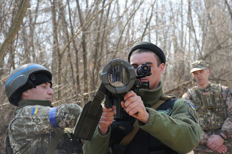 Ukrainian servicemen study a Swedish shoulder-launched weapon system during a training session near Kharkiv. AP Photo