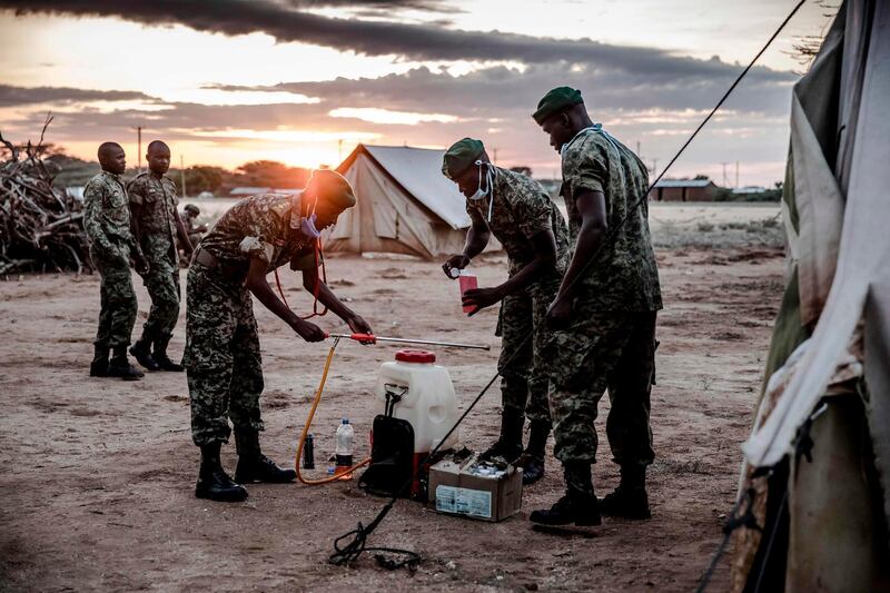 Members of Kenya's NYS -National Youth Service prepare tp spray pesticides to kill the swarms of locusts.