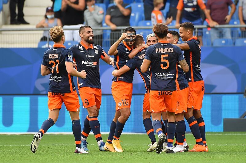 Montpellier's French defender Arnaud Souquet (C) is congratulated by team mates after scoring a goal during the French Ligue 1 football match between Montpellier and Angers on September 20, 2020 at the Mosson stadium in Montpellier, Southern France. (Photo by Sylvain THOMAS / AFP)