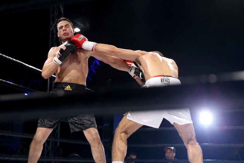 Fayad v Masrar. Fayad, in white, hits Masrar, in black, during their bout. Sammy Dallal / The National