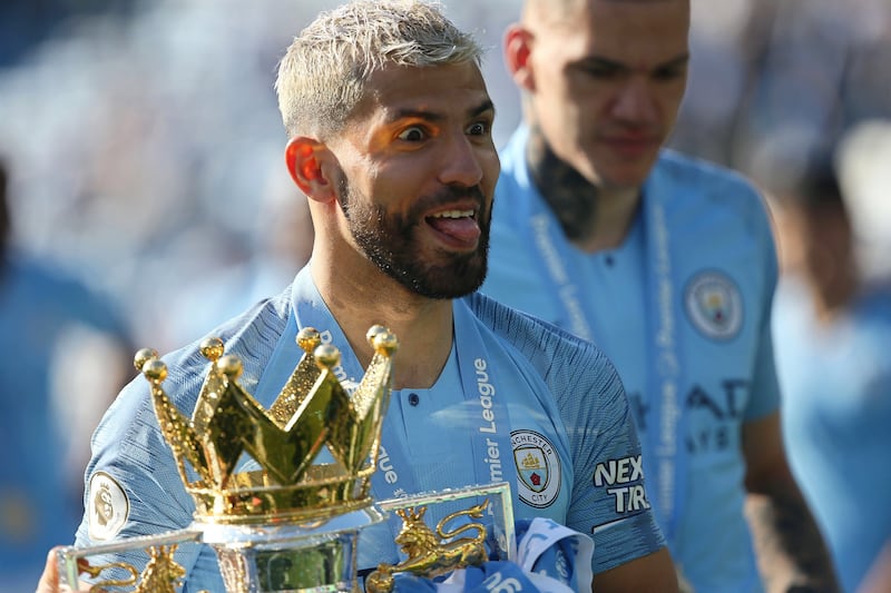 Manchester City's Sergio Aguero celebrates with the Premier League trophy after the match against Brighton and Hove Albion in May 2019. EPA