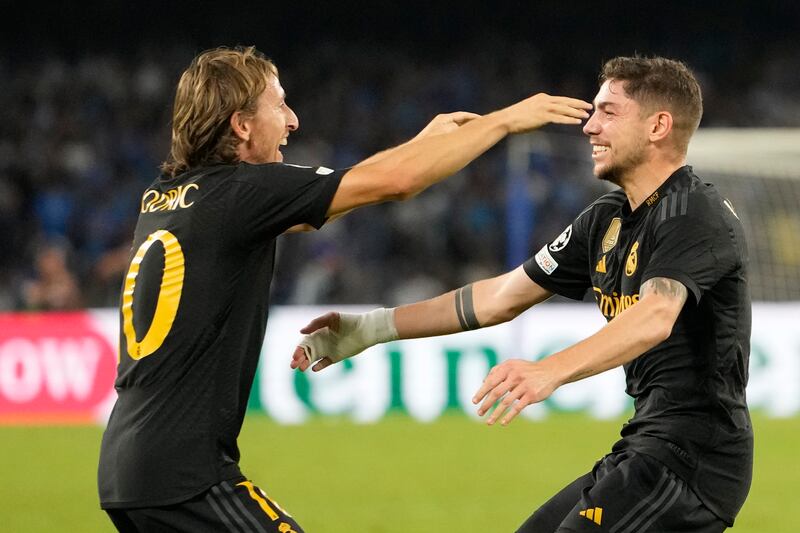Real Madrid's Luka Modric, left, celebrates with Federico Valverde his team's third goal during the Champions League match against Napoli on Tuesday, October 3, 2023. AP