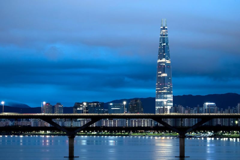 The Lotte Corp. World Tower, right, and other buildings stand illuminated at dawn in Seoul, South Korea, on Friday, Aug. 11, 2017. South Korea'sÂ stocks and currencyÂ fell after President Donald Trump warned North Korea that if it "does anything" to the U.S. or its allies "things will happen to them like they never thought possible." Photographer: SeongJoon Cho/Bloomberg via Getty Images