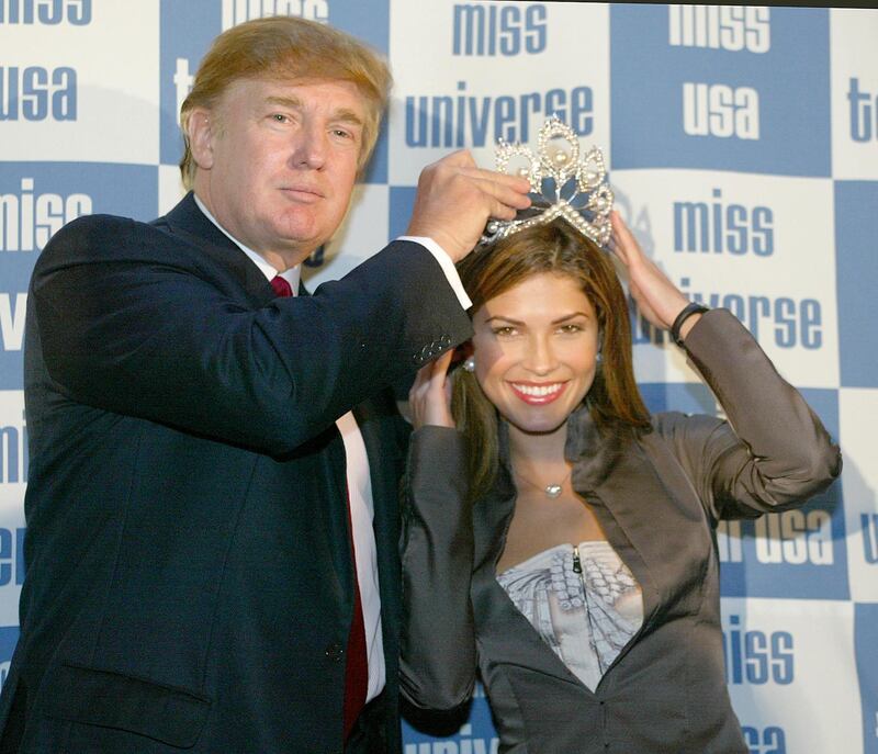 Miss Universe first runner-up Miss Panama Justine Pasek is crowned by pageant co-owner Donald Trump at a New York news conference 24 September 2002 to announce that the Miss Universe Organization has fired the woman wearing its crown. Oxana Fedorova, a 24-year-old Russian law student, was sacked four months after she won the pageant for allegedly being married and putting on weight. It is the first time in the pageant's 52 year history that the Miss Universe Organization has fired the woma wearing the crown.  AFP PHOTO/Timothy A. Clary (Photo by Timothy A. CLARY / AFP)