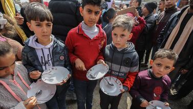 RAFAH, GAZA - MARCH 06 Palestinian children carry empty bowls during a march demanding an end to the war and an end to the famine that citizens suffer from due to the war on March 6, 2024 in Rafah, Gaza. As of Thursday February 29th, more than 30,000 people had been killed in Gaza since the start of the war on Oct. 7, according to the territory's health ministry. Also this week, more details have emerged of a potential new ceasefire deal that could start before Ramadan, pending further negotiations by Israel, Hamas and foreign mediators.(Photo by Ahmad Hasaballah / Getty Images)