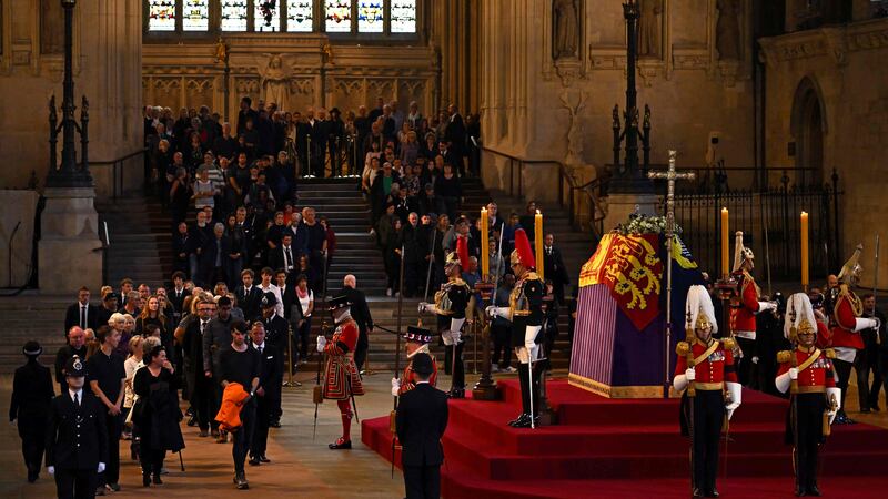 Members of the public pay their respects as they pass the coffin of Britain's Queen Elizabeth II as it lies in state inside Westminster Hall, London. AFP