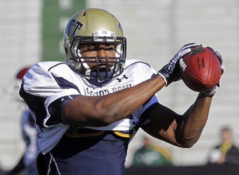 Dorin Dickerson, shown here while playing at Pittsburgh in college, made two costly plays last week for the Detroit Lions, which knocked them out of play-off contention. He later admitted that he suffered a concussion during the game. Dave Martin / AP Photo