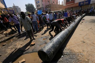 Protesters clear a road as they march during a rally against military rule in Khartoum, Sudan, on January 9. Photo: Reuters 