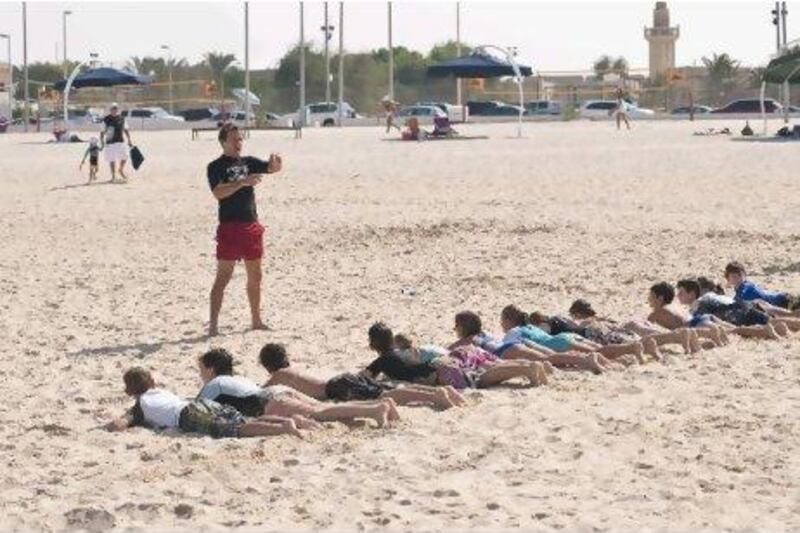 A Bondi Rescue lifeguard teaches children about water safety in Dubai.