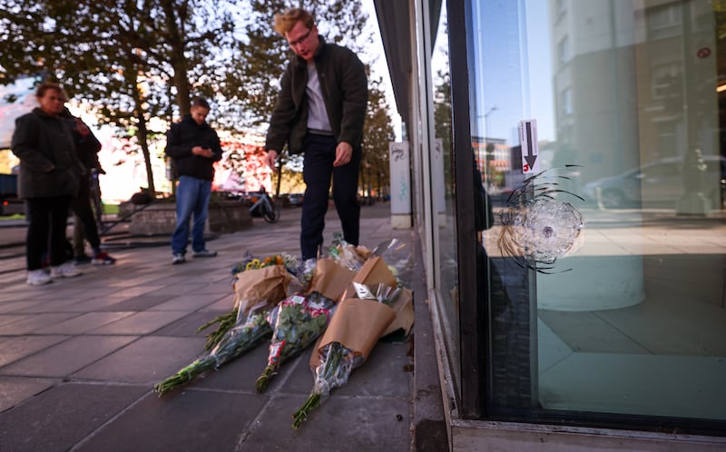 People lay flowers at the spot where two football supporters from Sweden were shot dead in a terror attack in Brussels, Belgium, on October 17, 2023. EPA