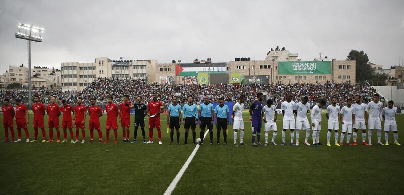 The Saudi and Palestinian national football teams listen to their national anthems during a World Cup 2022 Asian qualifying match between Palestine and Saudi Arabia in the town of al-Ram in the Israeli occupied West Bank. The game would mark a change in policy for Saudi Arabia, which has previously played matches against Palestine in third countries. Arab clubs and national teams have historically refused to play in the West Bank, where the Palestinian national team plays, as it required them to apply for Israeli entry permits. AFP