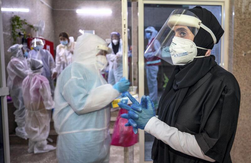 Abu Dhabi, United Arab Emirates, June 22, 2020.   
STORY BRIEF: Police patrols knocking on doors offering free Covid-19 tests to residents in buildings in AD downtown, Al Bakra Street area.
--  Healthcare workers prepping up before doing door to door tests.
Victor Besa  / The National
Section:  NA
Reporter:  Haneen Dajani