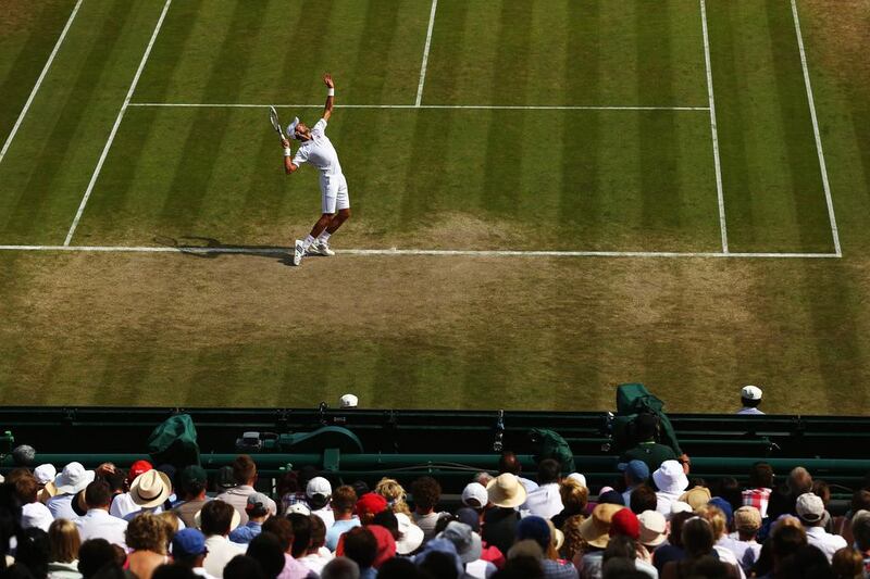 Novak Djokovic serves during his singles match against Marin Cilic on Wednesday at the 2014 Wimbledon Championships quarter-finals. Djokovic beat Cilic in five sets after going 2-1 sets down. Clive Brunskill / Getty Images