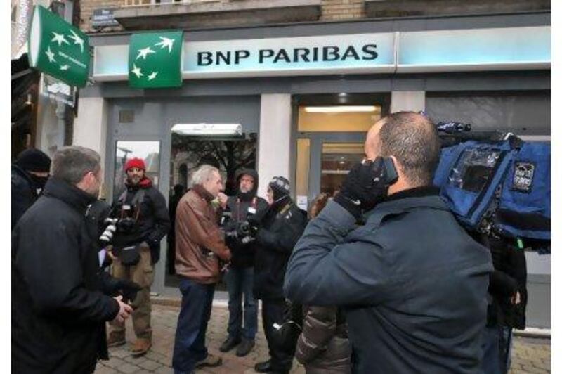 Journalists await the arrival of Eric Cantona outside the BNP bank of Albert, where the former football star had said he would make a withdrawal as part of his contribution to a planned bankrun.