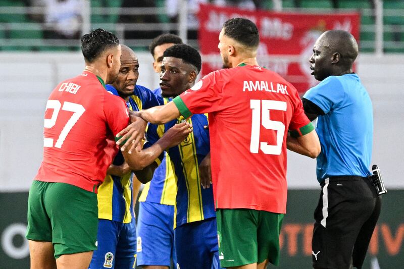 Tanzania defender Ibrahim Hamad argues with Morocco defender Mohamed Chibi and midfielder Selim Amallah as referee Al Hadi Allou Mahamat tries to intervene. AFP