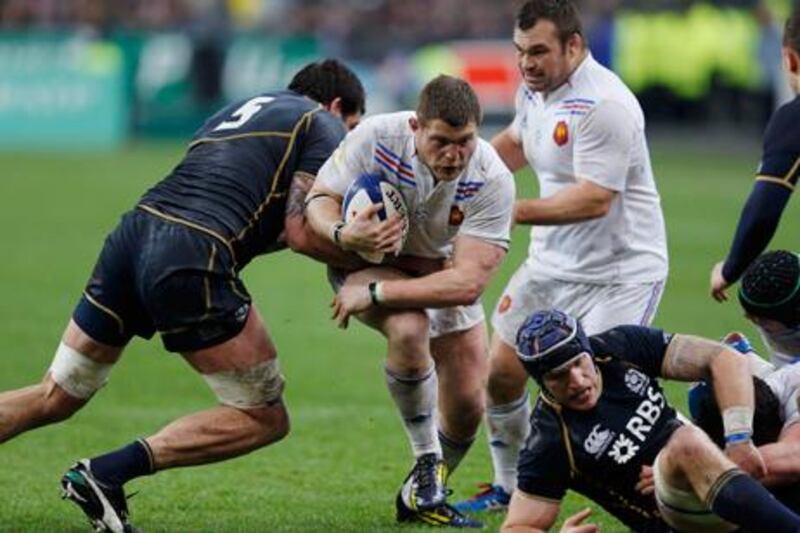 France's Benjamin Kayser looks for a way through the Scotland ranks at the Stade de France.