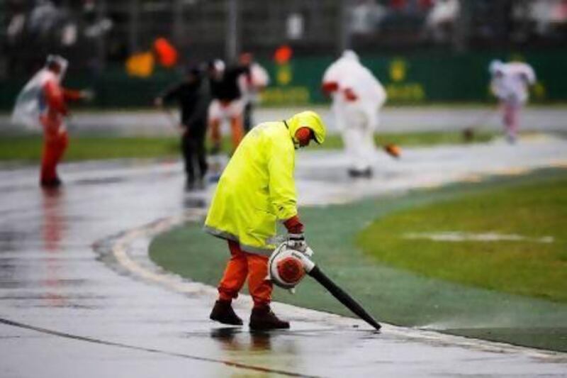 Despite the marshals' best efforts to clear water from the track Saturday's qualifying session for the Australian Grand Prix was pushed back to Sunday.
