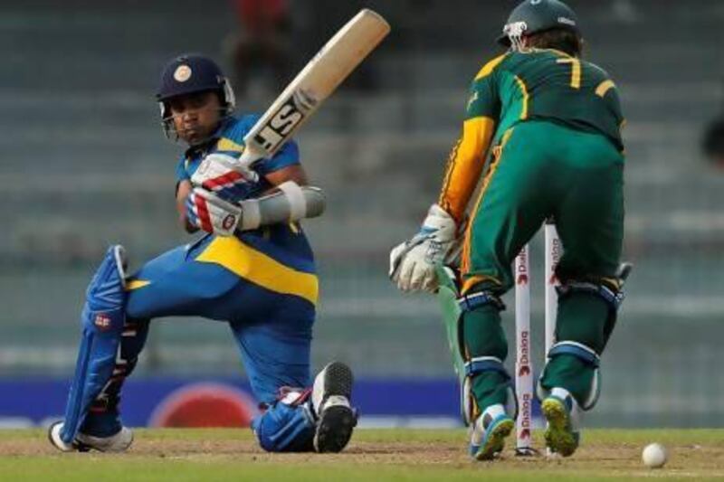 Mahela Jayawardene bats as South African wicketkeeper AB de Villiers watches in the second ODI. Eranga Jayawardena / AP Photo
