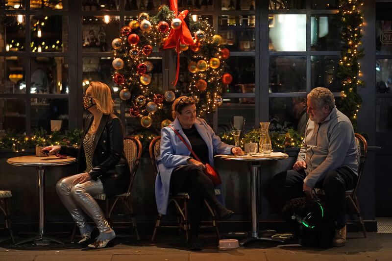 Outdoor tables at a restaurant on Old Compton Street in Soho, London. PA