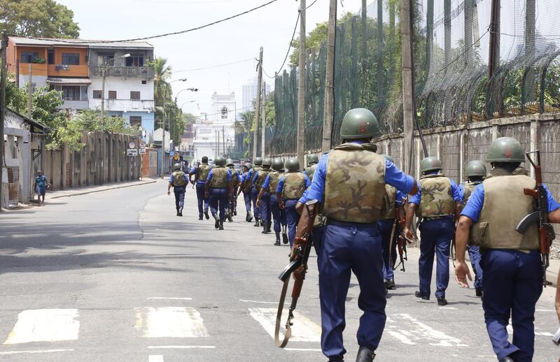 Armed policemen patrol the area near St Anthony's Shrine.  EPA