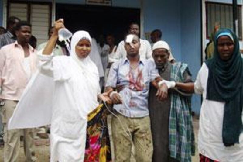 A Somali journalist wounded in the explosion is assisted by nurses outside Madina hospital in Mogadishu.