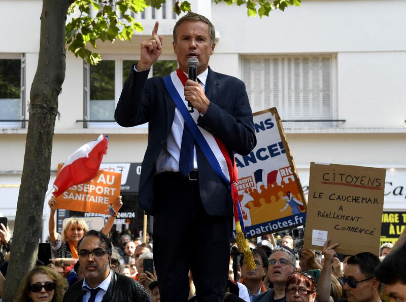 Nicolas Dupont-Aignan, leader of  Debout la France, a right-wing party, addresses anti-vaccine protesters near the Louvre in Paris.