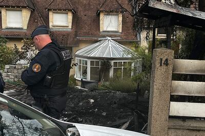 A Police officer stands in front of the house of the Mayor of L'Hay-les-Roses, Vincent Jeanbrun. AFP