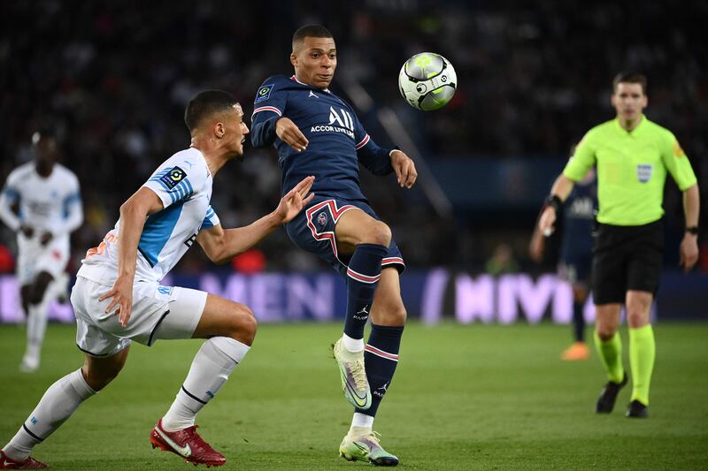 Marseille's French defender William Saliba fights for the ball with Paris Saint-Germain's French forward Kylian Mbappe. AFP