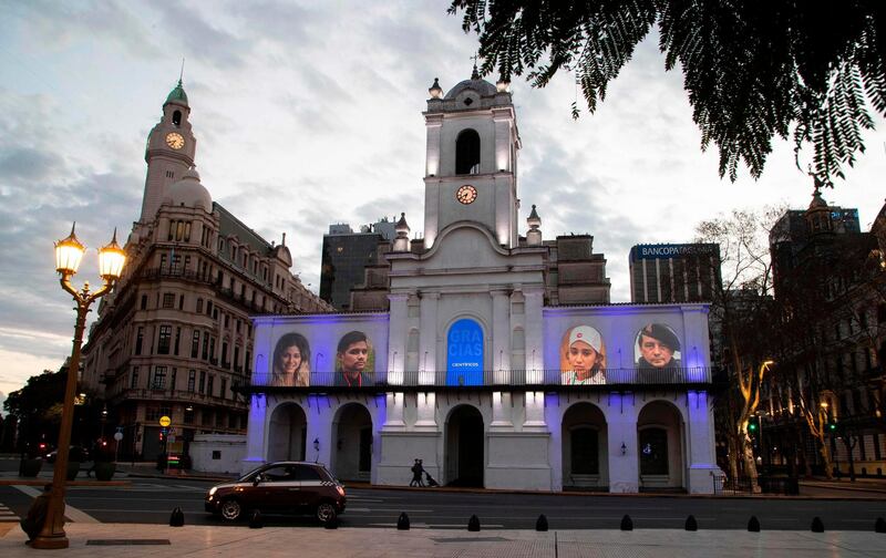 Portraits of essential workers are projected in the facade of the historic Cabildo of Buenos Aires in Argentina. AFP